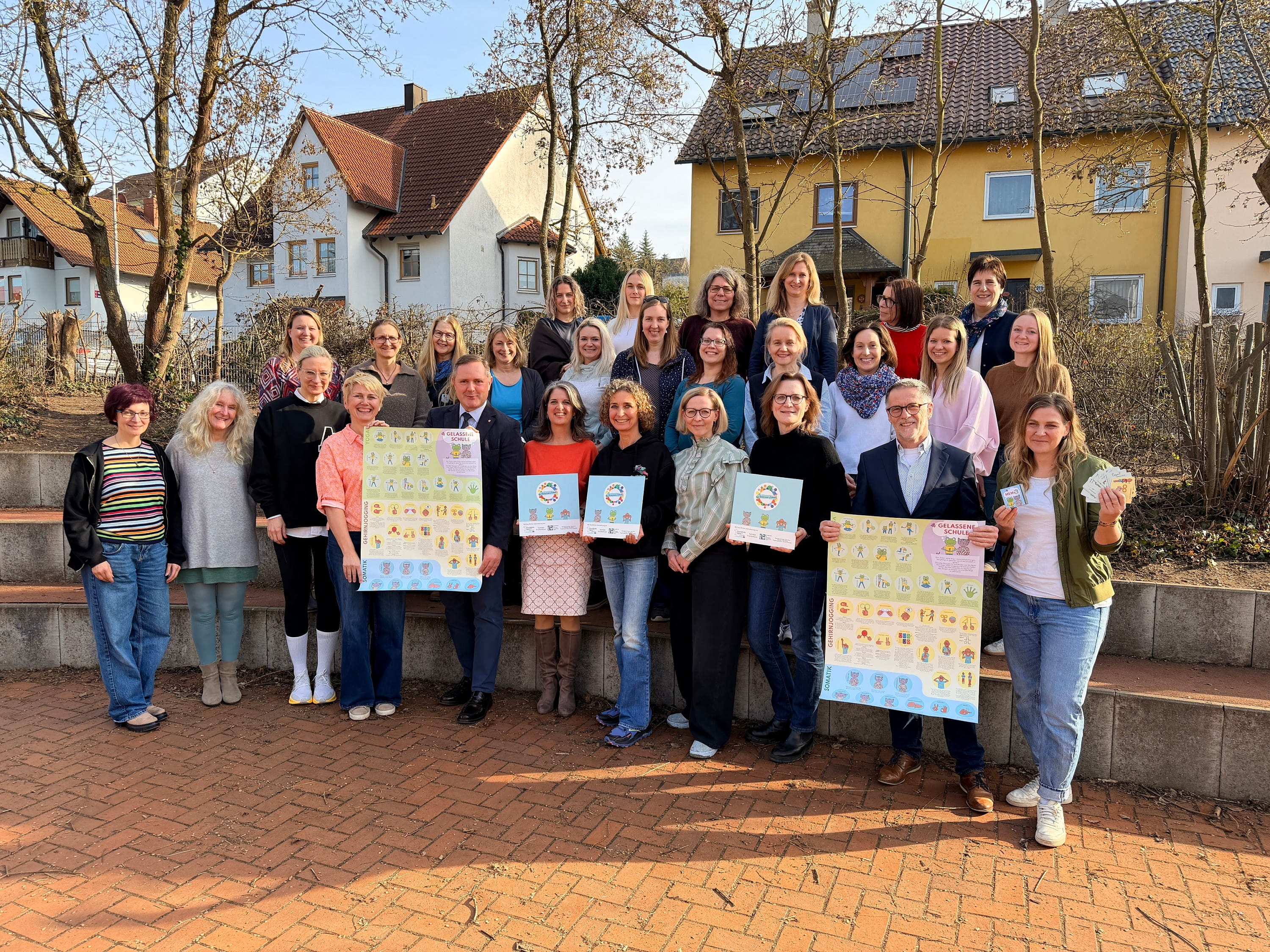 Gruppenfoto: Lehrkräfte und Schulleitungen trafen sich mit den Initiatoren des Präventionsprogramms „Gelassene Schule“ an der Grundschule in Cadolzburg, um ihre Schilder als Zeichen der erfolgreichen Teilnahme an der Initiative entgegen zu nehmen.